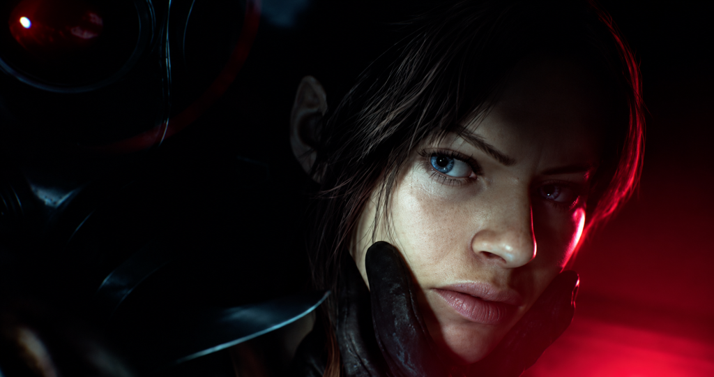 Krupan kadar Claire Redfield sa ozbiljnim izrazom lica dok je obasjava crveno-plavo svetlo u mračnoj i napetoj atmosferi Resident Evil Veronica teasera.